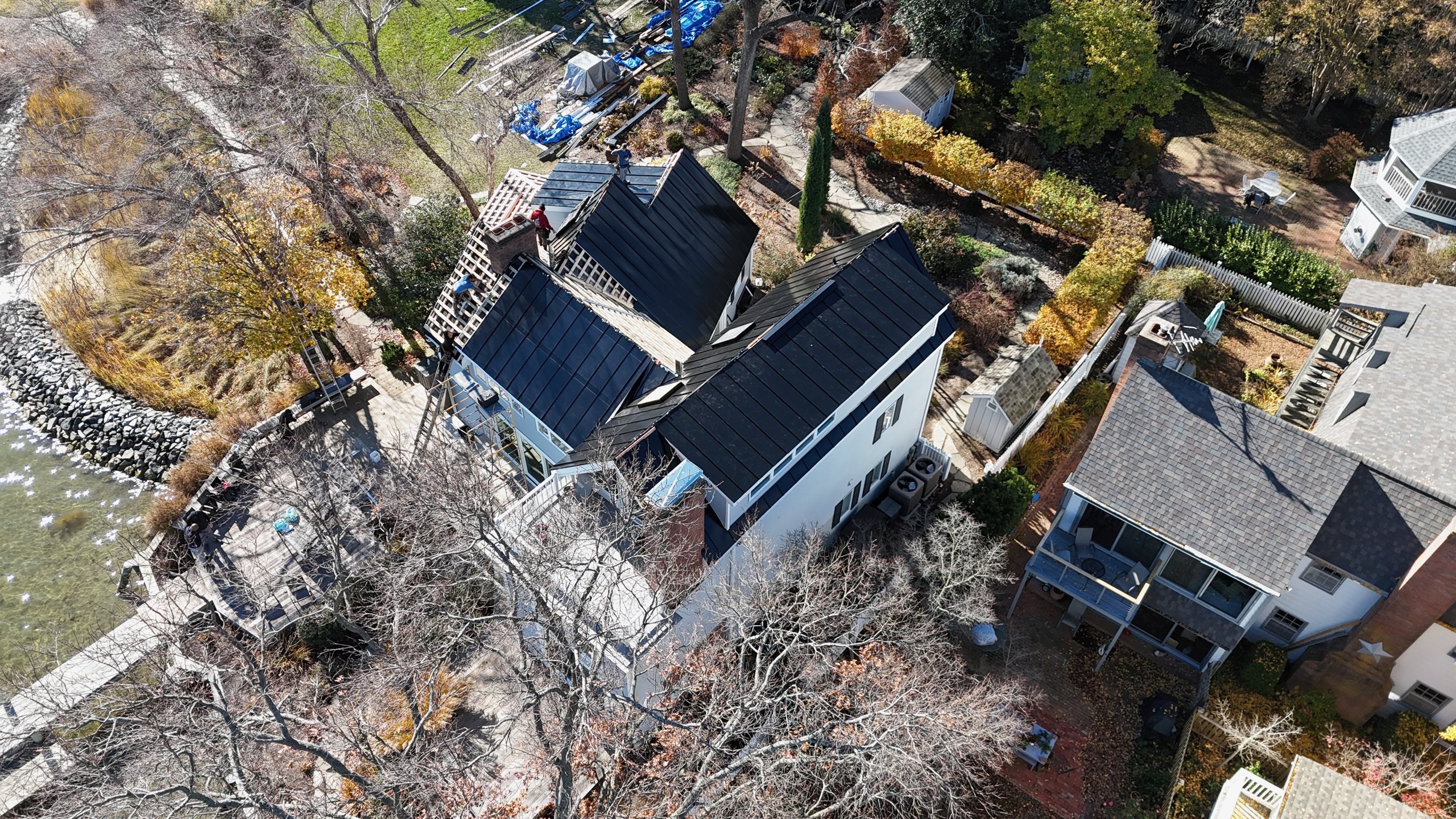 Aerial view of an ArcEdge integrated solar metal roof on a waterfront home